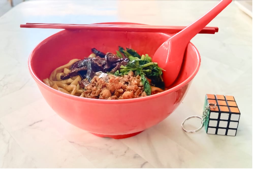 A bowl of noodles, taken from a 45-degree view
